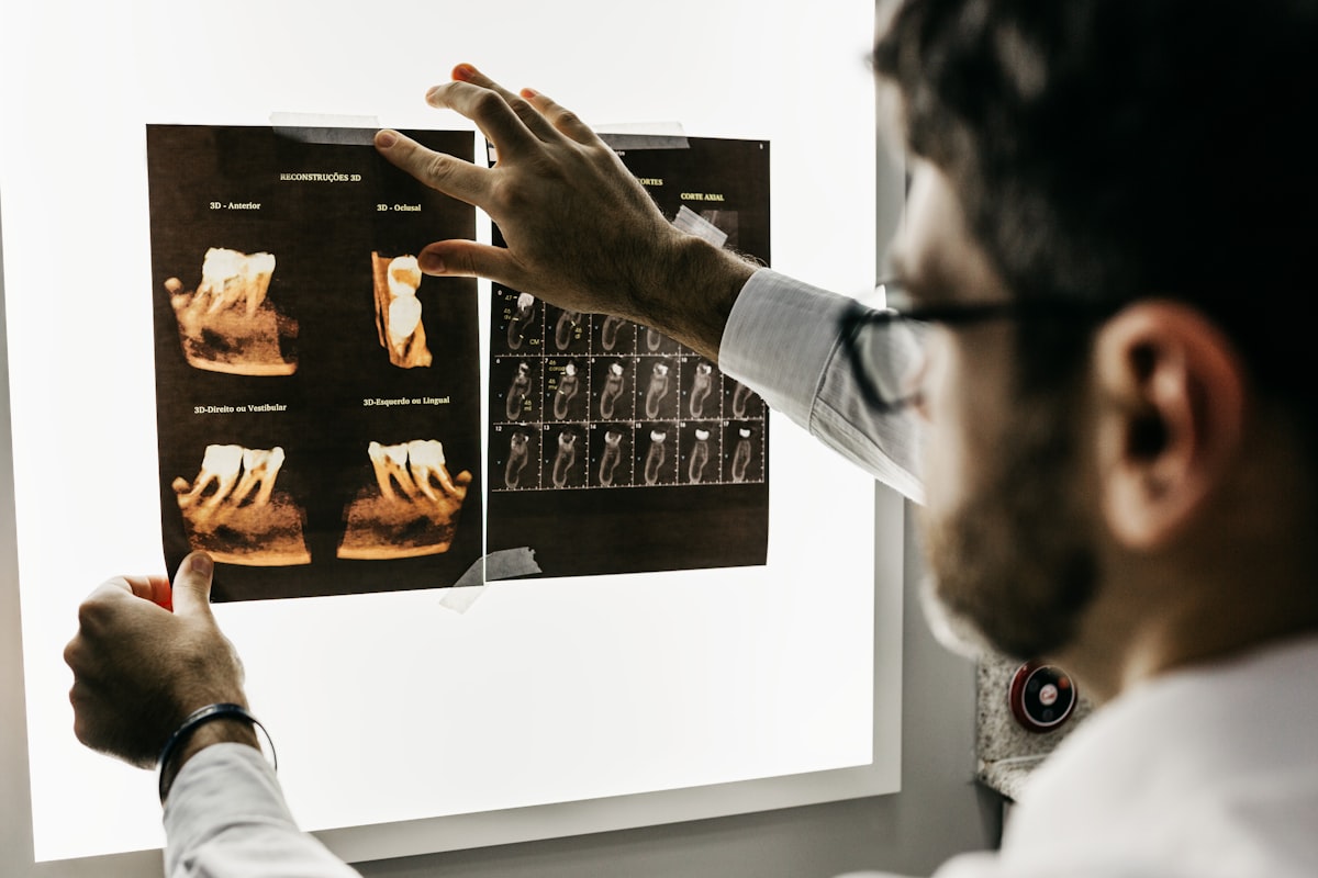 A dentist studying 3D dental scans on a lightboard